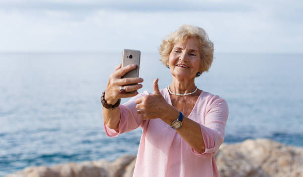 istock Mature woman taking selfie on beach 1065309870