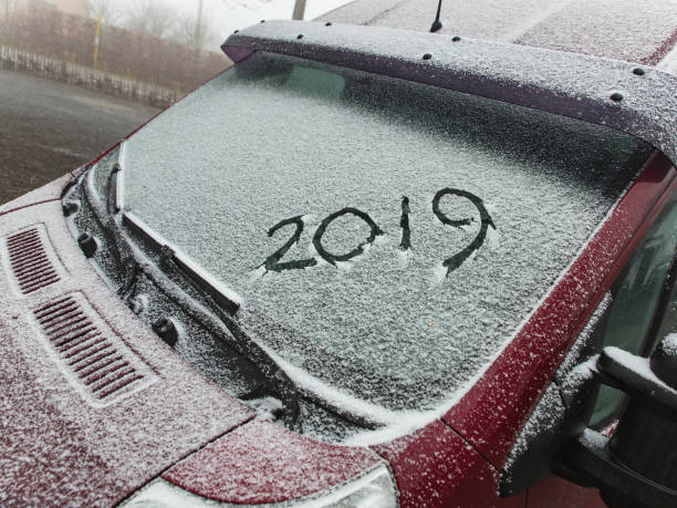 istock Car with snow where the numbers are written 2019 1065315284