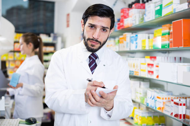 istock Male pharmacist is inventorying medicines 1065315814