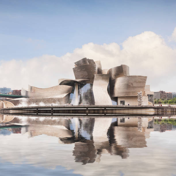12 May 2015: Bilbao, Basque Country, Spain - The Guggenheim Museum by Frank Gehry reflected in the River Nervion.