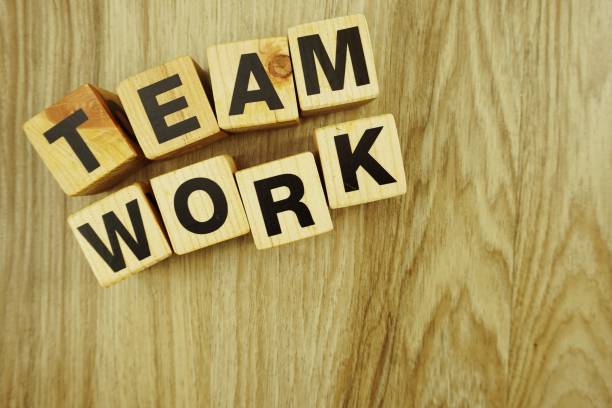 istock teamwork word made from wooden cubes with letters alphabet 1065324430