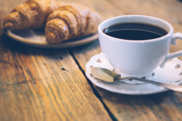 istock Black coffee and croissant. Typical French Breakfast (Petit DÃ©jeuner) background. 1065324460