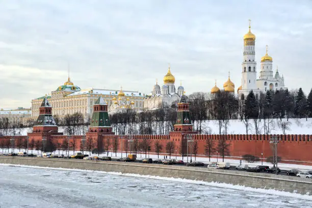 MOSCOW, RUSSIA - The Kremlin Embankment in Winte. Winter view of Kremlevskaya Embankment, the frozen river Moskva, and amazing architectural ensemble of Moscow Kremlin from Bolshoi Moskvoretsky Bridge
