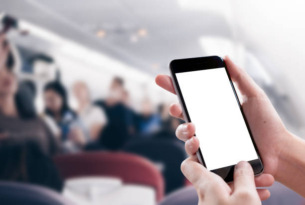istock Close up Woman hand Using a Smart Phone with blank screen on airplane. 1065326912