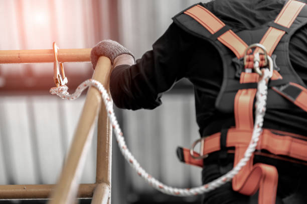 Worker wearing safety harness. Construction worker wearing safety harness and safety line working high place at industrial. safety harness photos stock pictures, royalty-free photos & images