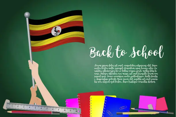 Vector illustration of Vector flag of Uganda on Black chalkboard background. Education Background with Hands Holding Up of Uganda flag. Back to school with pencils, books, school items learning and childhood concept.