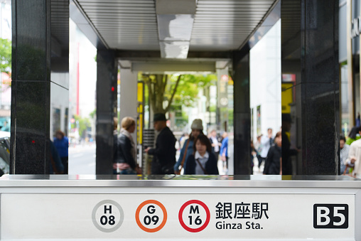 Tokyo, Japan - April 19, 2014 : Pedestrians around the entrance of the Ginza Station in Tokyo, Japan. Ginza Metro Station Enterance . Ginza shopping district, the most expensive real estate price in Japan.