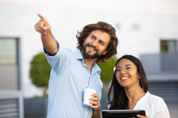 Successful architect showing something to colleague with tablet