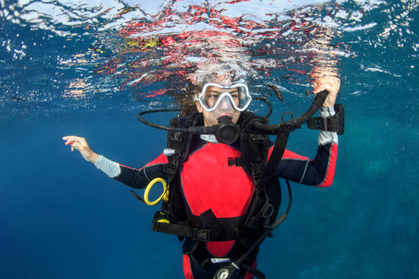 istock Scuba diver girl swimming below the water surface 1065334696