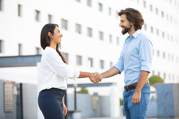 istock Lucky multicultural partners shaking hands on meeting in city 1065334698