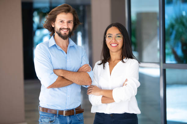 istock Successful multicultural partners posing with crossed arms near office building 1065334734