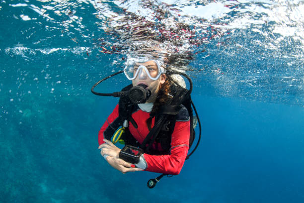 istock Scuba diver girl swimming below the water surface 1065334764