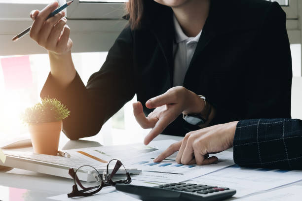 istock Business team two managers working on accounting documents and team work together to present the work and help solve the problem. 1065334872