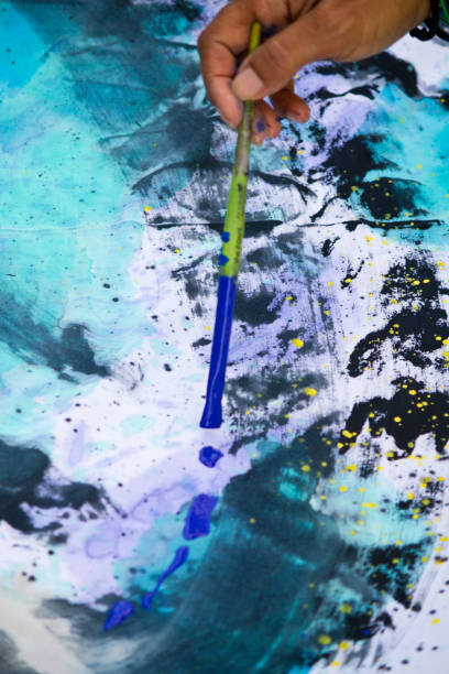 istock hand with a paintbrush painting 1065336140