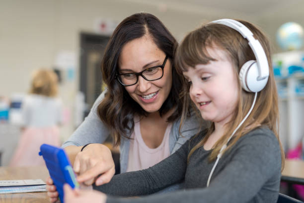 istock Teacher helping a first grader in her classroom 1065336694