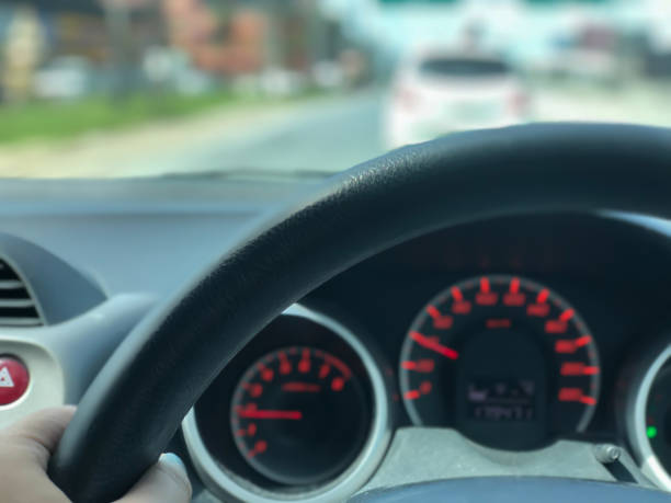 istock woman hand on the steering wheel 1065336734