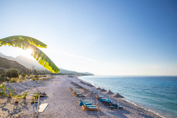 istock Sunrise over an empty beach with umbrellas 1065337030