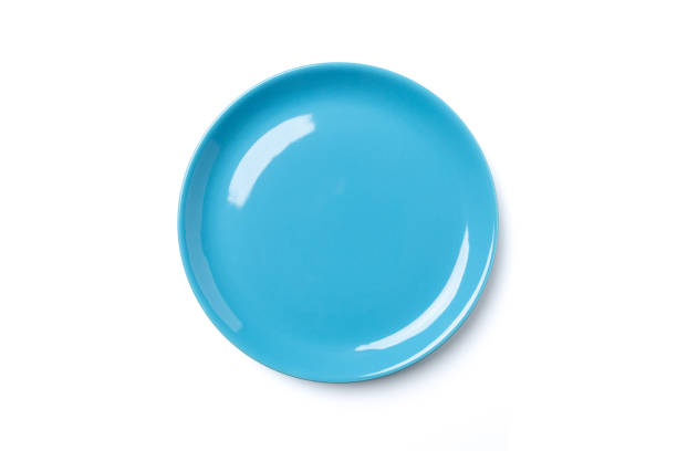 istock Pastel blue colored plate isolated on white background. 1065338882