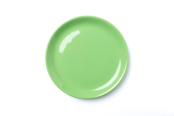 istock Pastel green plate isolated on white background 1065338980