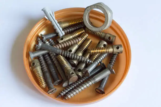 thread; connection; threaded connection; bolt; nut; self-tapping screw; anchor; fasteners; background; white; brown; material; metal; plastic; technology; manufacturing; cover;