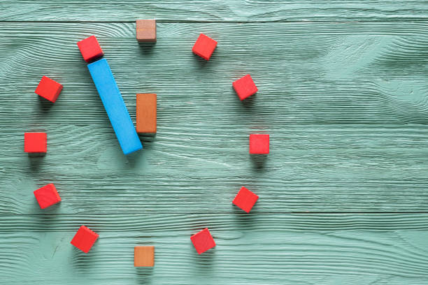 istock Colorful clock from wooden cubes, five minutes to twelve. 1065346770