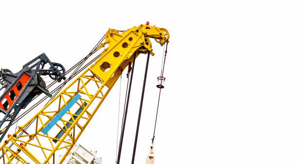istock Big yellow construction crane for heavy lifting isolated on white background. Construction industry. crane for container lift or at construction site. Crane rental business concept. Crane dealership. 1065348270