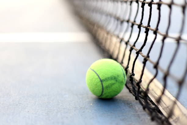 istock Close up tennis ball on the courts background 1065352086
