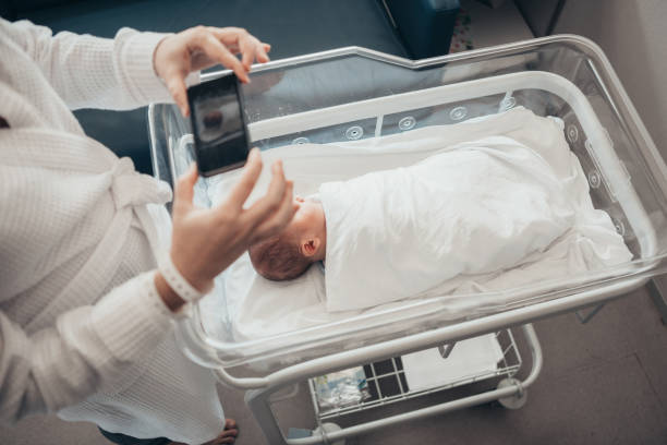 istock Mother photographing newborn son 1065360238