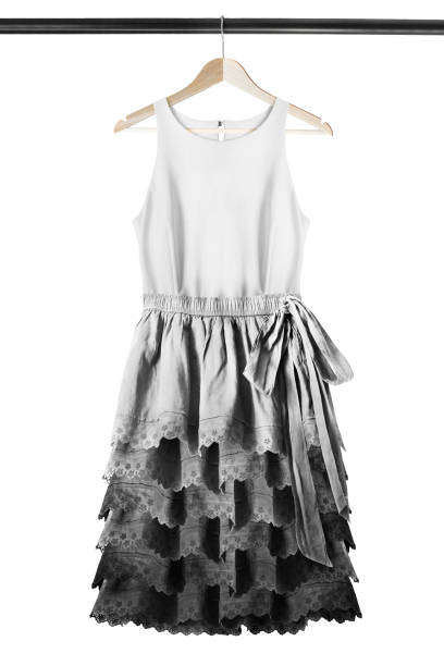 Black and white elegant dress hanging on wooden clothes rack isolated over white