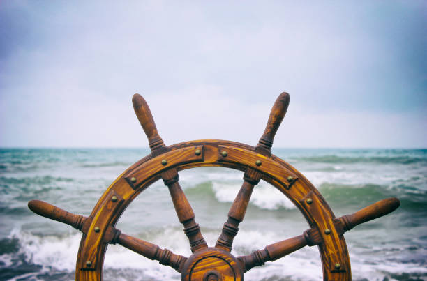 istock Steering hand wheel ship on sea background 1065362294