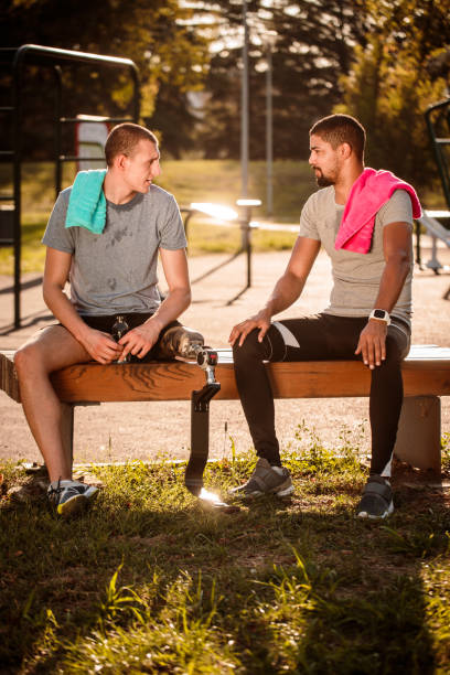 istock Friends resting after exercise in outdoor gym 1065364870