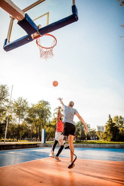 istock Friends playing basketball 1065365472