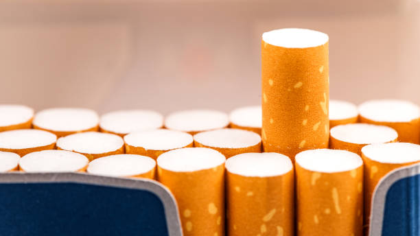 istock Cigarettes in a pack closeup on white background. Smoking tobacco. Bad habit. 1065365574