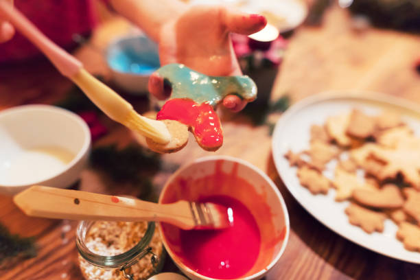 istock Child hands are decorating Christmas cookies 1065365608