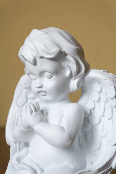 istock Statue of angel with folded hands praying 1065370832