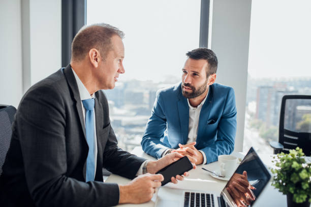 istock Business men using laptop and mobile phone 1065375360