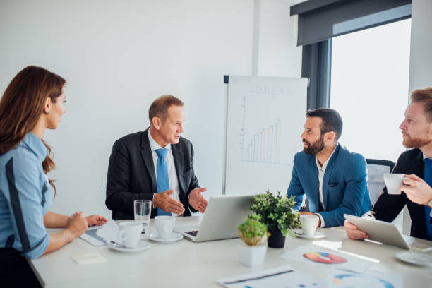 istock Business man talking to coworkers 1065375568