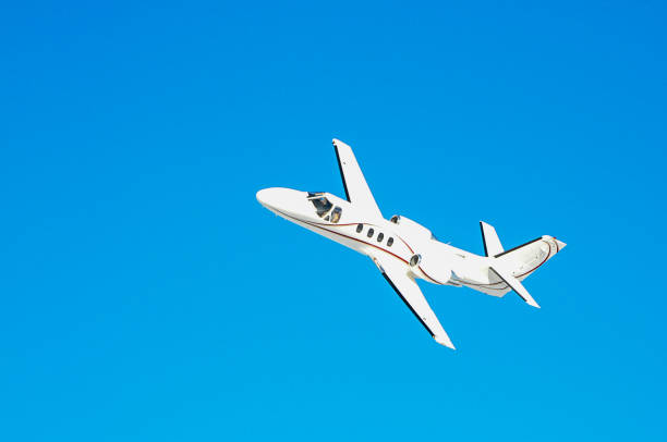 istock A white private plane flies in blue sky 1065379256