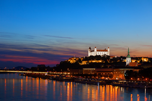 Bratislava city skyline at blue hour twilight with reflection on Danube river in Slovakia