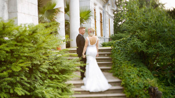 istock Beautiful Wedding couple posing in fornt of old structure 1065386370