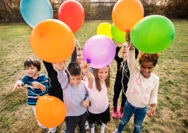 istock Cheerful kids playing with balloon's 1065386612
