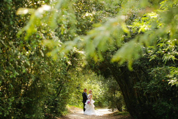 istock Beautiful Wedding couple posing in park 1065386640