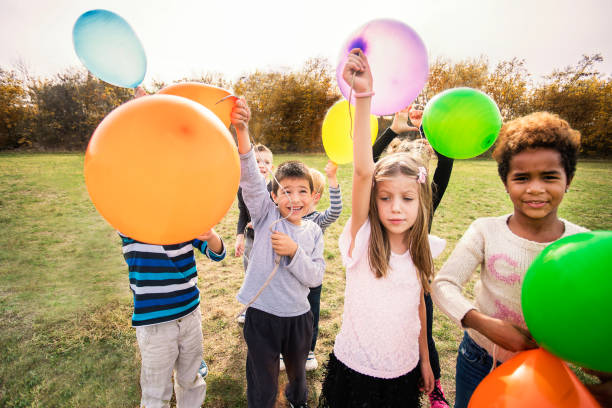 istock Cheerful kids playing with balloon's 1065386674