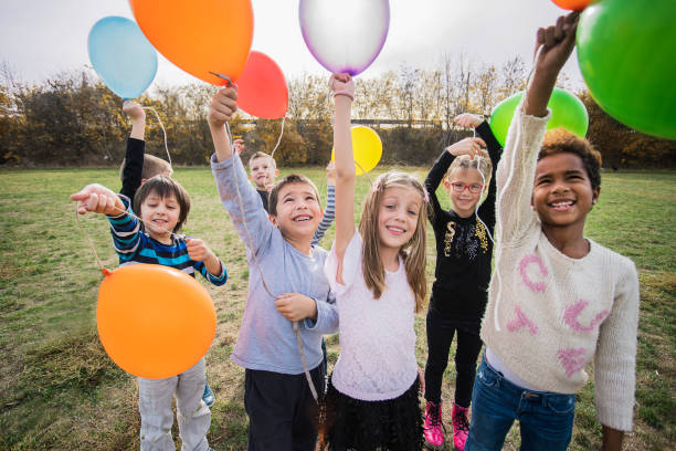 istock Cheerful kids playing with balloon's 1065386946
