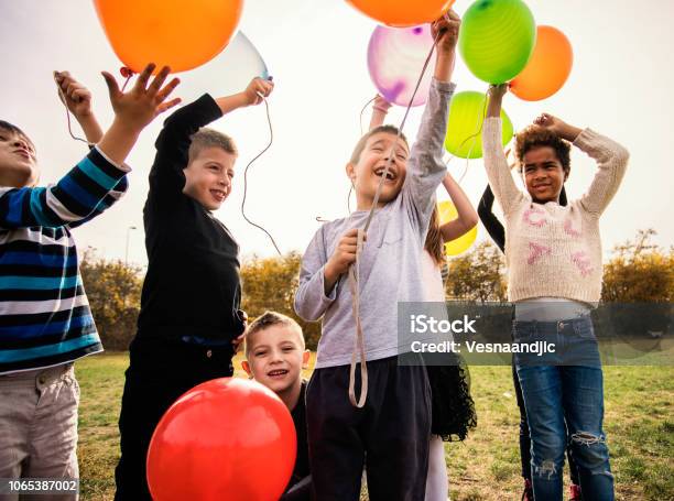 Cheerful Kids Playing With Balloons Stock Photo - Download Image Now - Balloon, Child, Happiness