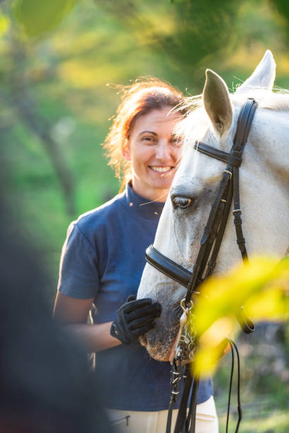 istock Smiling woman with horse 1065387362