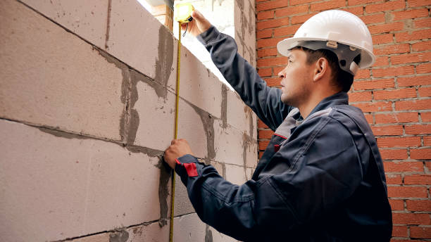 istock Man measuring length of window in building 1065389944