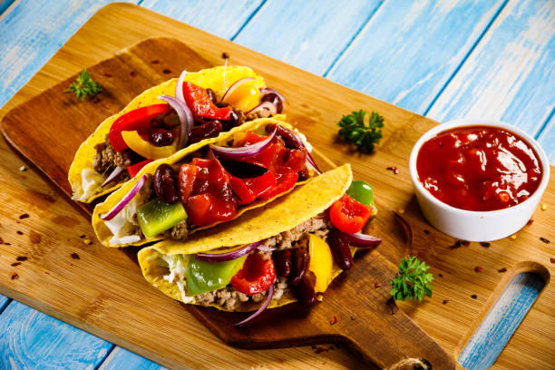 istock Tacos on cutting board on wooden table 1065393084