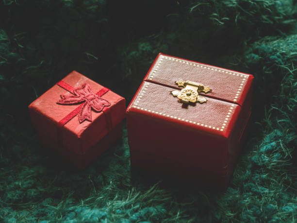 istock Red gift box on green soft background. Surprise, comfort, warmth, care concept 1065395094