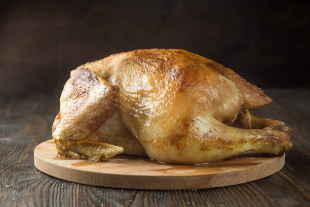 istock Roasted chicken on wooden background 1065395224